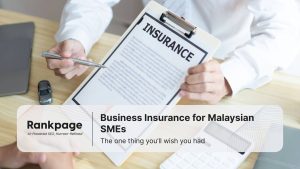 Agent showing business insurance document to client protection options for Malaysian SMEs