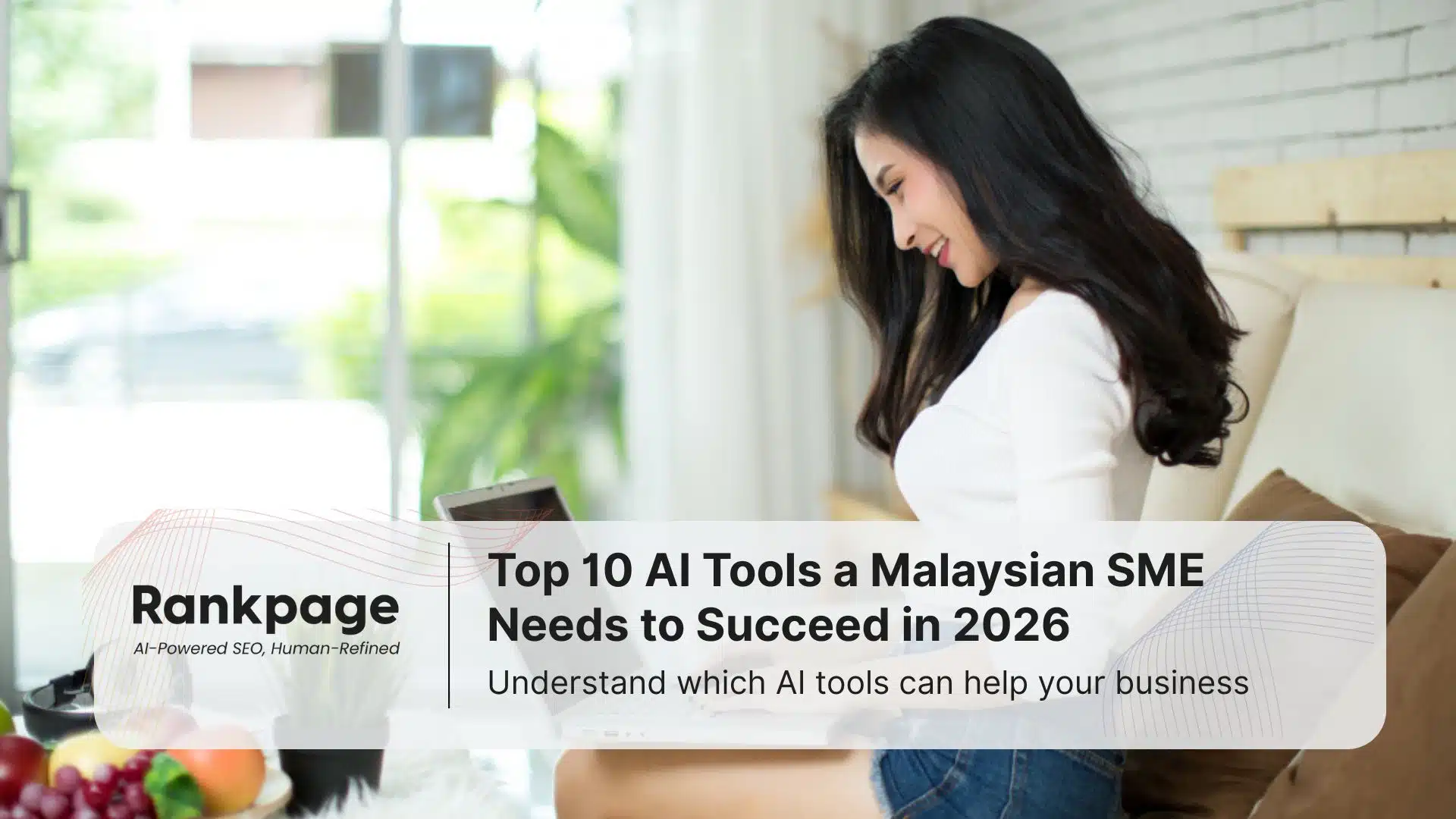 A pretty lady sits using her laptop, working to improve her SME in Malaysia.