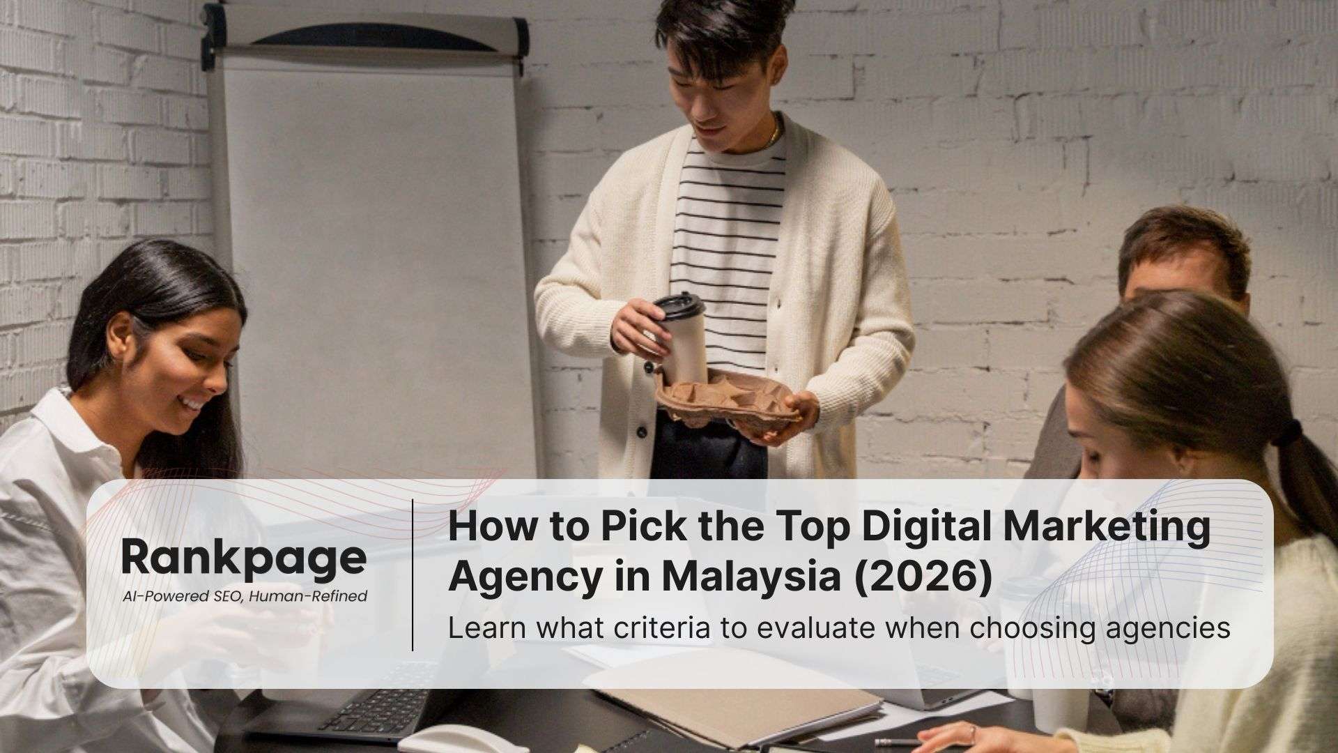 Three colleagues in a digital marketing agency sit around discussing a project
