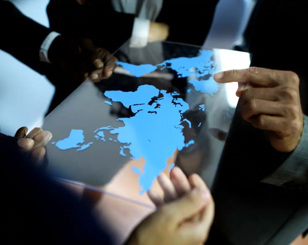 A group of businesspeople pointing at a map