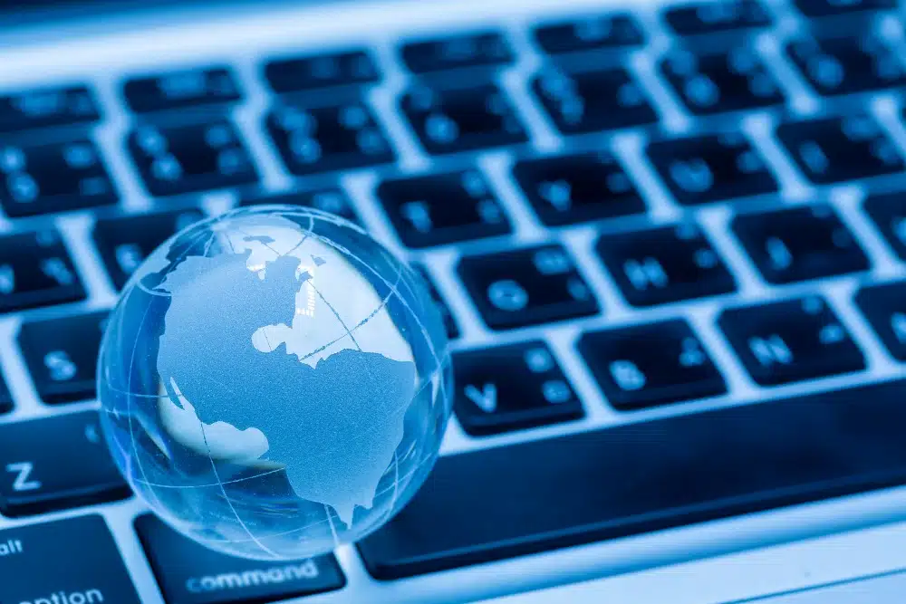A keyboard with a glass globe on top of it