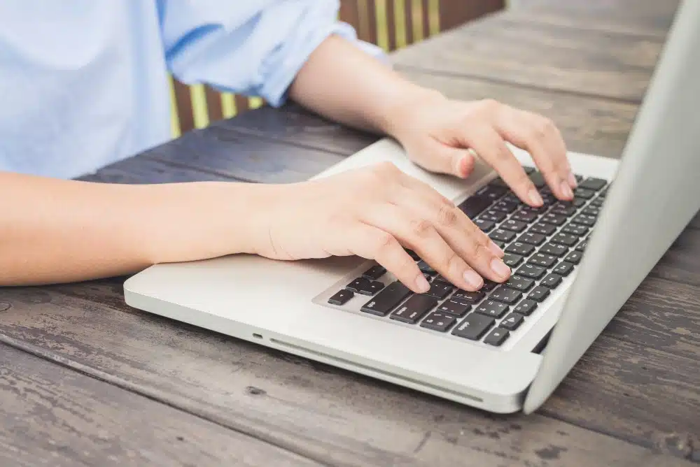 Man typing on a laptop