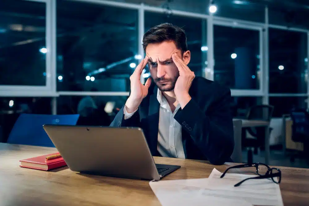 A stressed businessman at his computer