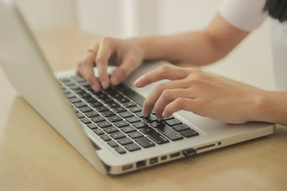 Person typing on laptop
