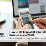 Photo of a man's hand. He is holding a phone and tapping on the screen to navigate a website, symbolizing UI UX