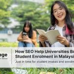Two university students sitting on the grass and happy