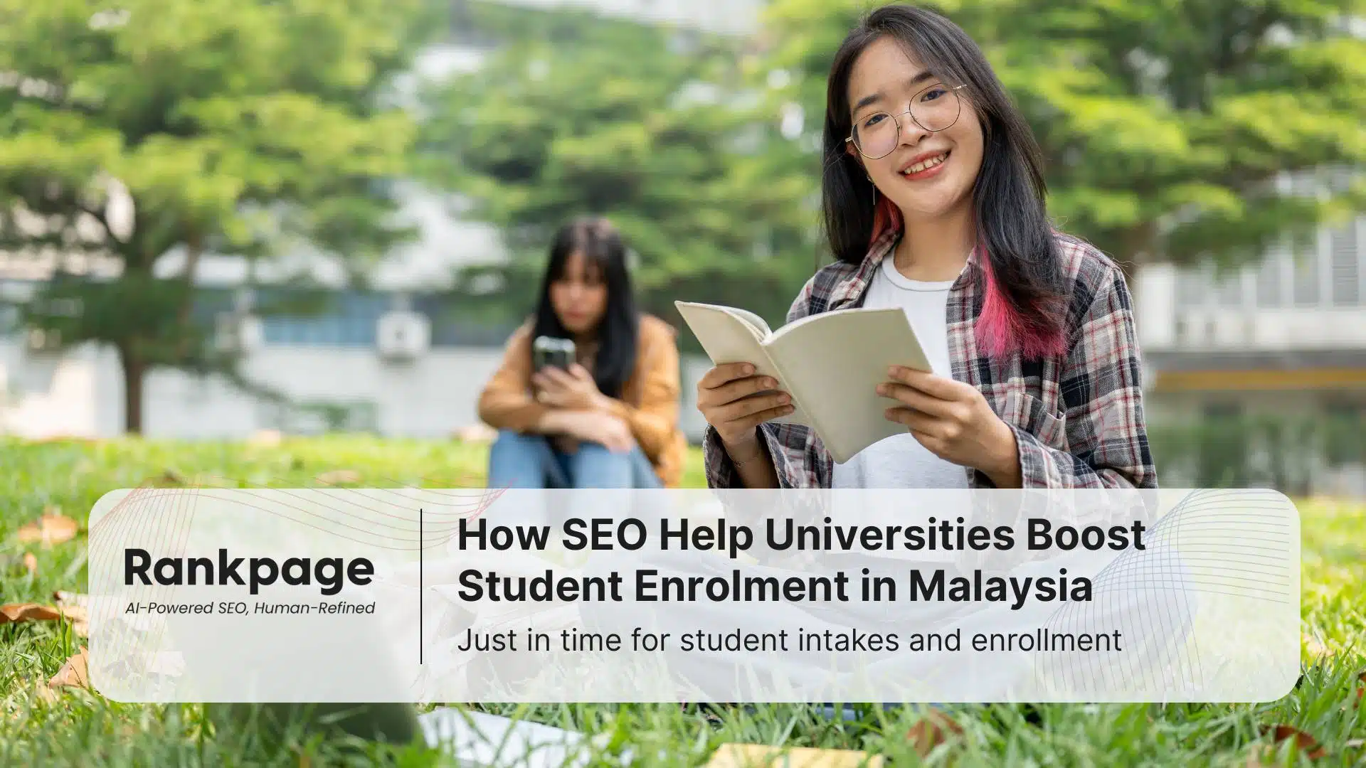 Two university students sitting on the grass and happy