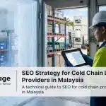 A logistics worker monitoring temperature data on a tablet inside a cold storage warehouse in Malaysia near a port.